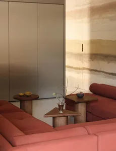 Modern sofa in a minimalist living room with a fabric upholstery and wooden furniture.