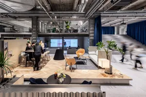 A modern coworking space with a mix of materials and furniture.