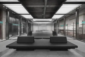 Modern industrial office lobby with metallic surfaces and minimalist design.