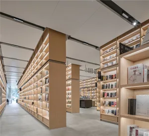 A modern library with minimalist design, featuring wooden shelves filled with books.