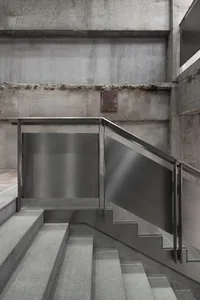 Modern staircase with concrete steps and walls.