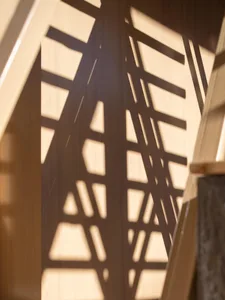 A pattern of light and shadow created by a geometric design on a wall.