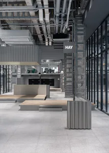 Modern, industrial-style office space with metal furniture and exposed pipes