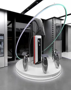 A futuristic, metallic exhibit display with sleek, curved designs and illuminated elements.