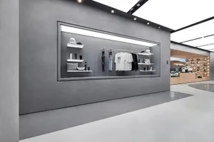 Modern retail storefront featuring minimalist design with concrete walls and sleek, urban aesthetics.