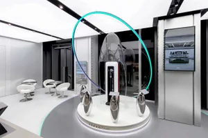 Modern car dealership interior with sleek design, glass walls, and minimalist furniture.