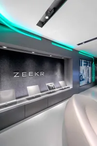 Modern retail storefront with large glass windows and wall-mounted displays.
