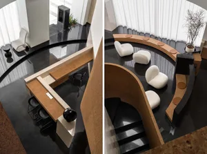 A modern office space with a glass wall, wooden desk, and white chairs.