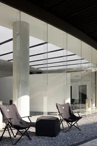 Modern office space with glass and concrete walls.