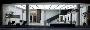 A modern office with a glass wall providing natural light.