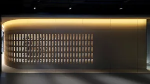 A modern retail storefront with a metallic grid design.