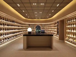 Modern wine shop interior with wooden finishes and extensive wine bottle display.