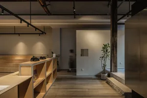 Industrial storefront with wooden shelves and concrete flooring and walls