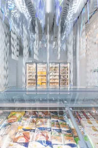 Minimalist grocery store interior with transparent glass walls and ceiling.