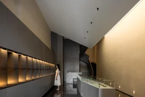A minimalist lobby interior featuring concrete walls and flooring.