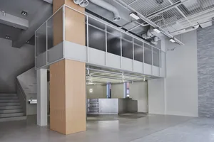 An image of a minimalist office space with concrete walls and a sleek, modern design.