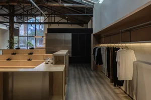 Modern retail shop with minimalist design featuring wood, metal, and glass materials