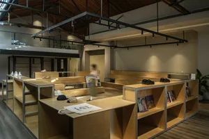 Minimalist retail storefront featuring wooden elements and display cases.