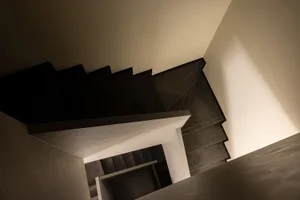 Modern black marble staircase with a sleek, minimalist design.