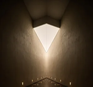 A modern interior design featuring contemporary lighting and concrete walls.
