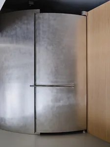 A modern metal door with a sleek, curved design, featuring a horizontal handle.