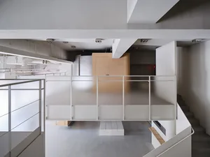 Modern office space with concrete flooring and minimalist design.