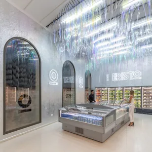 A modern grocery store interior featuring a refrigerated display case with neon lighting.