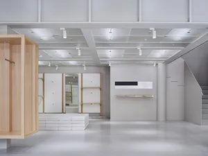 Modern retail space featuring minimalist design with concrete, wood, and metal materials.