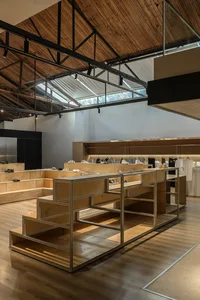 Modern retail store with industrial design features, showcasing minimalist aesthetic and use of wooden materials.
