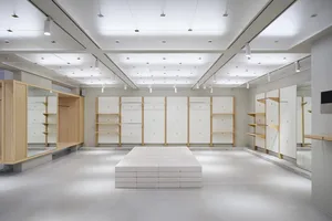 Modern retail space with minimalist design and concrete paneling.