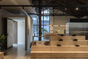 Modern retail store with wooden interior, featuring minimalist design and industrial-style elements.