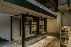 Minimalist showroom with concrete seating and wooden accents.