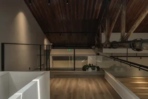 Industrial-style interior design featuring wooden ceiling and glass elements.