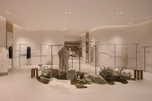 A minimalist retail space featuring concrete and glass design elements.