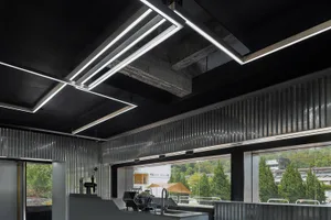 Modern coffee shop interior with metallic finishes and industrial design elements.