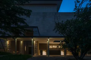 Modern library building with concrete facade and illuminated signage at night