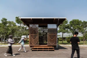 A modern library constructed with wooden materials and featuring a clear glass wall.