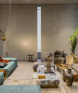 A modern living room featuring marble furniture and decorative elements.