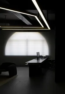 A modern office space featuring glass and concrete elements.