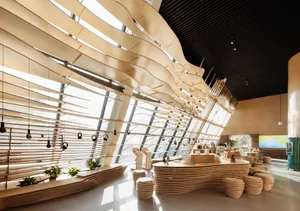 Lobby area of a modern coffee shop with wooden elements and headsets hanging on the ceiling.