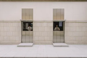 Two metal windows with stone bases in a modern commercial interior.