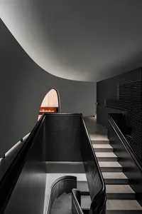 Modern interior design featuring black metallic stairs and escalator.