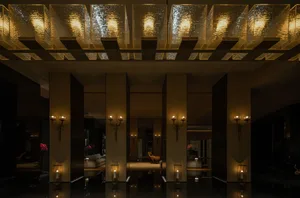 An elegantly designed hotel lobby featuring modern neoclassical fixtures and decor.