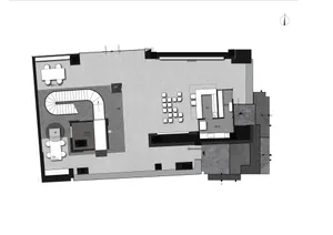An overhead view of a modern office space with a concrete floor plan.