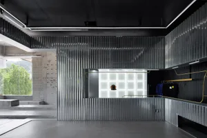 Industrial retail storefront with corrugated metal walls and illuminated display