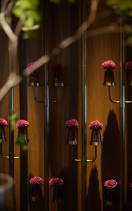 Beautiful, decorative floral arrangements displayed on a wooden wall.