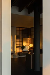 A modern residential interior featuring wooden and glass elements.