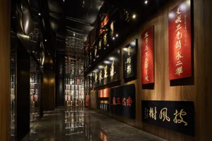 A modern restaurant corridor with metallic cladding and illuminated signage