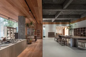 Interior of a minimalist art gallery featuring concrete and wooden elements.
