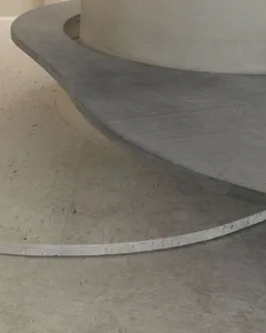 Close-up view of a minimalist interior space featuring concrete materials.